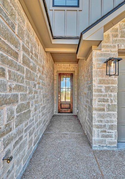 Property entrance featuring stone siding