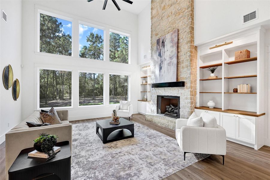 The spacious living area features an impressive wall of windows, allowing for an abundance of natural light to flood the home and create a warm, inviting atmosphere
