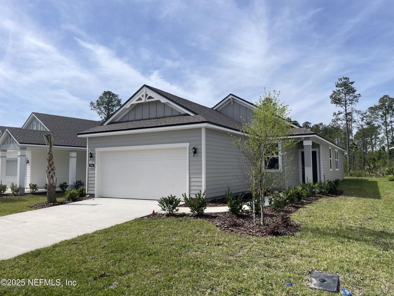 Front exterior of a new home in Palm Series at Seminole Palms, Palm Coast, FL, highlighting curb appeal (Image 20).