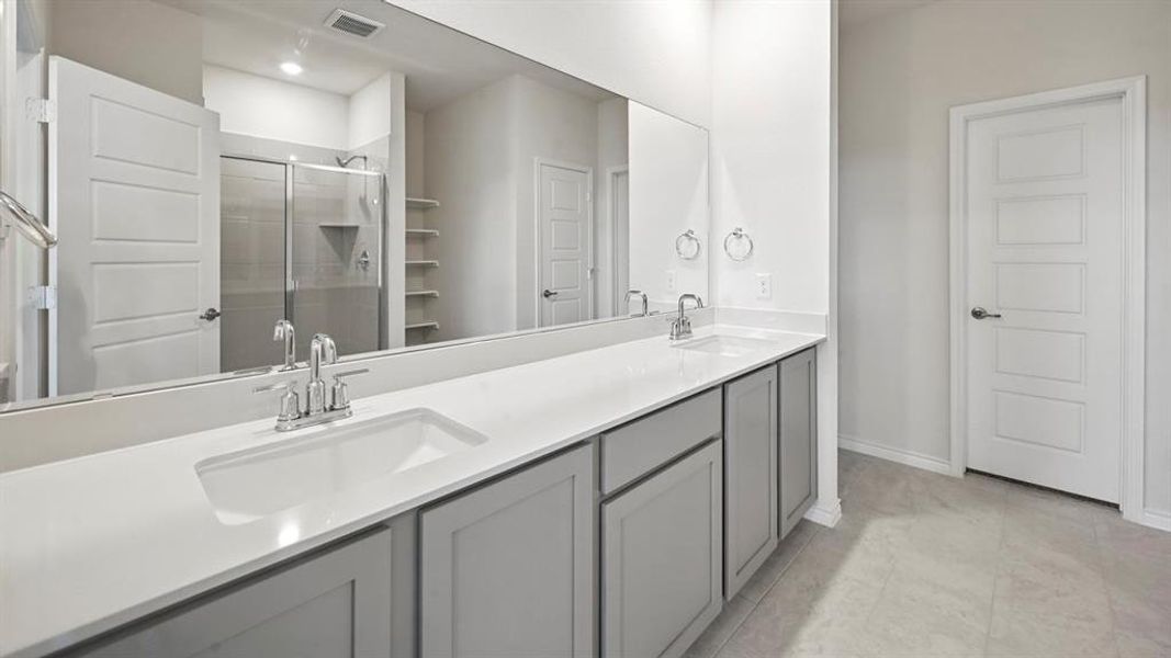 Full bathroom featuring double vanity and a shower stall Full bathroom featuring double vanity and a shower stall