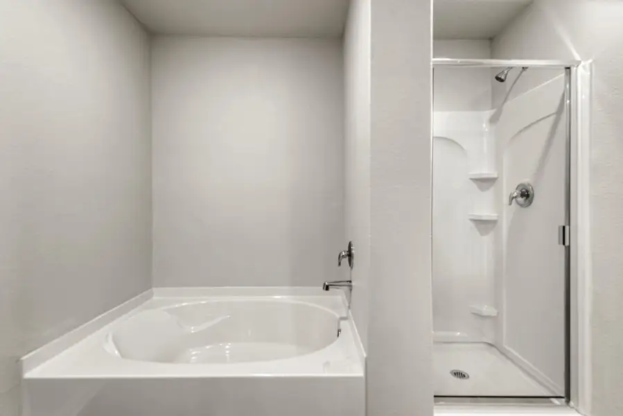 The luxurious primary bathroom has a soaking tub, standing shower, and a walk-in closet.