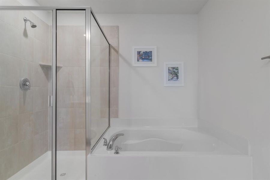 Full bath featuring a shower stall and a bath