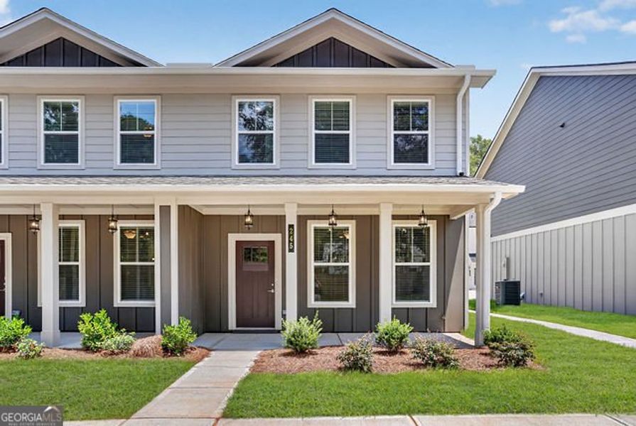 Front exterior of a new home in The Cottages at East Lanier, Fayetteville, GA, highlighting curb appeal (Image 14). Front exterior of a new home in The Cottages at East Lanier, Fayetteville, GA, highlighting curb appeal (Image 14).