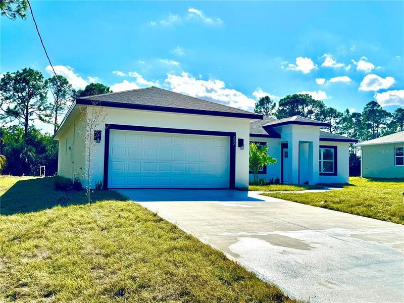 Front exterior of a new home in , Palm Bay, FL, highlighting curb appeal (Image 2). Front exterior of a new home in , Palm Bay, FL, highlighting curb appeal (Image 2).