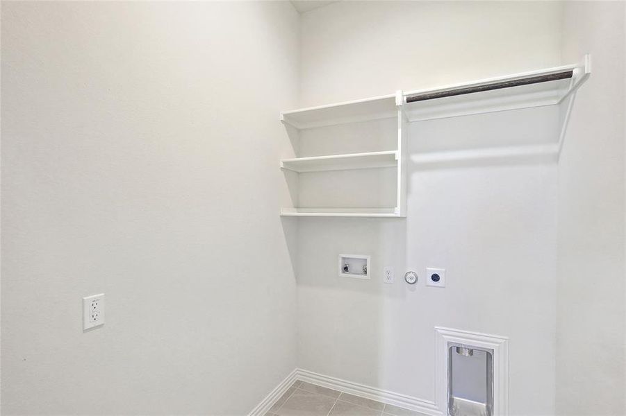 Laundry room with hookup for a washing machine, hookup for a gas dryer, hookup for an electric dryer, and light tile patterned floors