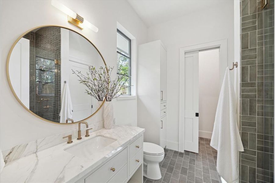 The first floor offers a full bath featuring tile from Ann Sacks & Studio McGee. It is conveniently located off the flex room and could be a pool bath or guest bathroom. It also has access to the pavilion.