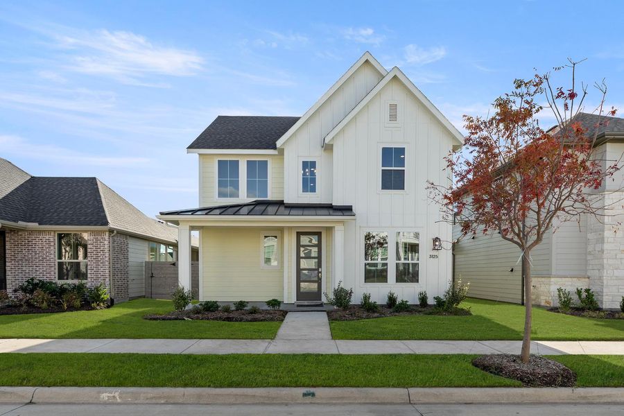 Front exterior of a new home in Carriage Collection at Painted Tree, McKinney, TX, highlighting curb appeal (Image 1).