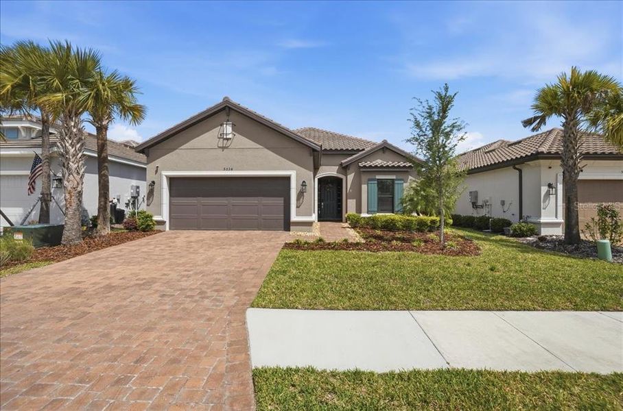 Front exterior of a new home in Esplanade at Artisan Lakes, Palmetto, FL, highlighting curb appeal (Image 20).