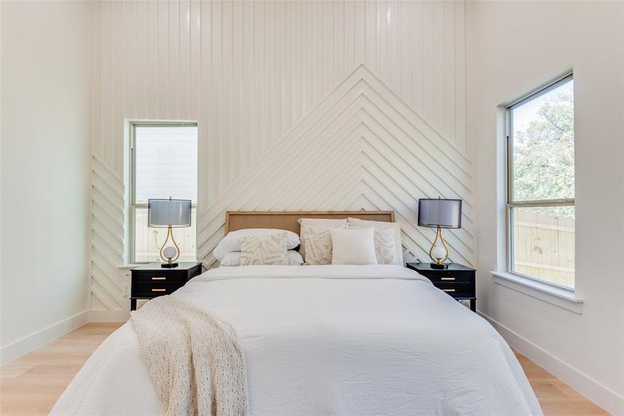 Bedroom with light hardwood / wood-style flooring