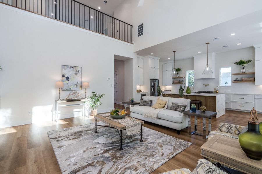 Open concept living space with soaring ceilings and natural light. Open concept living space with soaring ceilings and natural light.