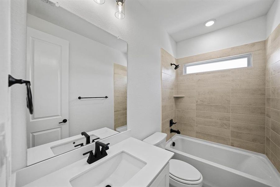 Bathroom featuring vanity and shower / bath combination Bathroom featuring vanity and shower / bath combination