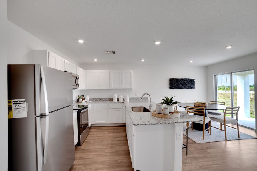 A kitchen with white cabinets.