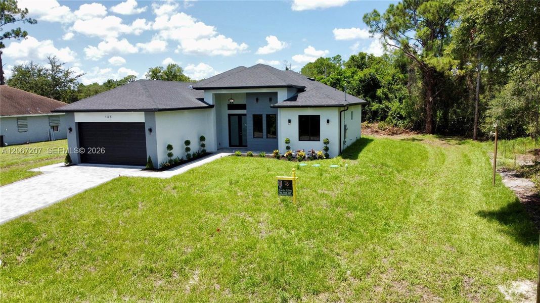 Front exterior of a new home in , Lehigh Acres, FL, highlighting curb appeal (Image 21). Front exterior of a new home in , Lehigh Acres, FL, highlighting curb appeal (Image 21).