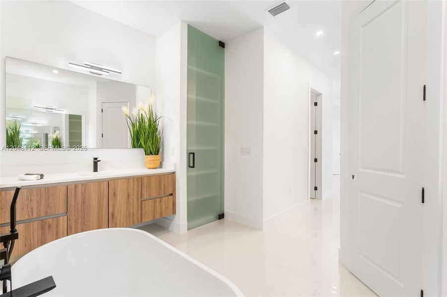 Dual sinks, CUSTOM VANITIES and QUARTZ SURFACES for a truly REJUVENATING Experience