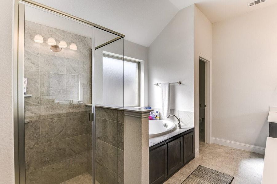 The en-suite has a separate water closet, tub, shower and custom tile-work.