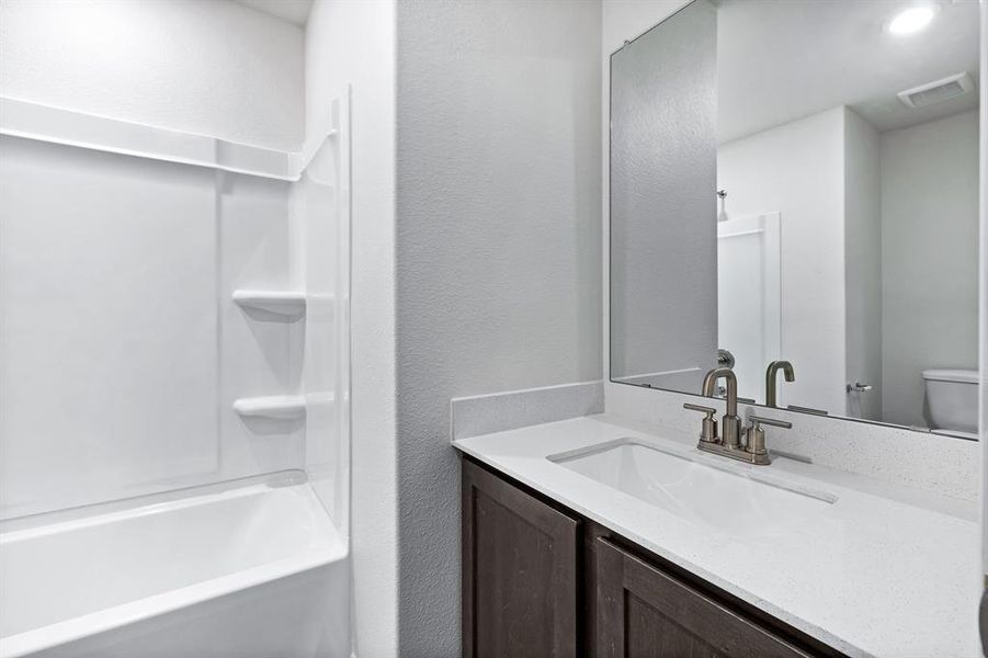 Full bathroom featuring shower / bathtub combination, vanity, and toilet