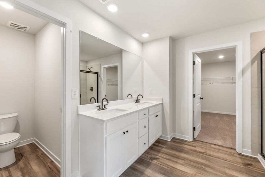 A bathroom with a sink and a toilet. A bathroom with a sink and a toilet.
