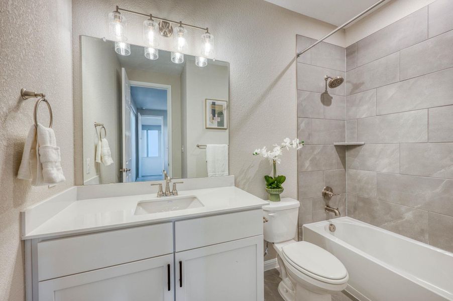 Tiled walls and a clean vanity define this modern bathroom space. Tiled walls and a clean vanity define this modern bathroom space.