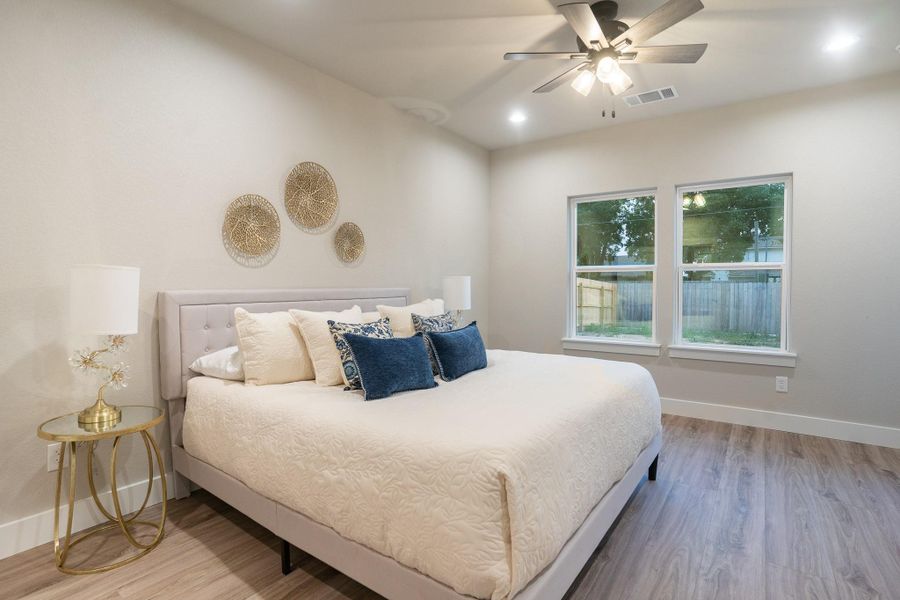 Bedroom with wood finished floors, baseboards, a ceiling fan, and recessed lighting