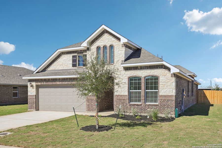 Front exterior of a new home in Carmel Ranch, Schertz, TX, highlighting curb appeal (Image 1).