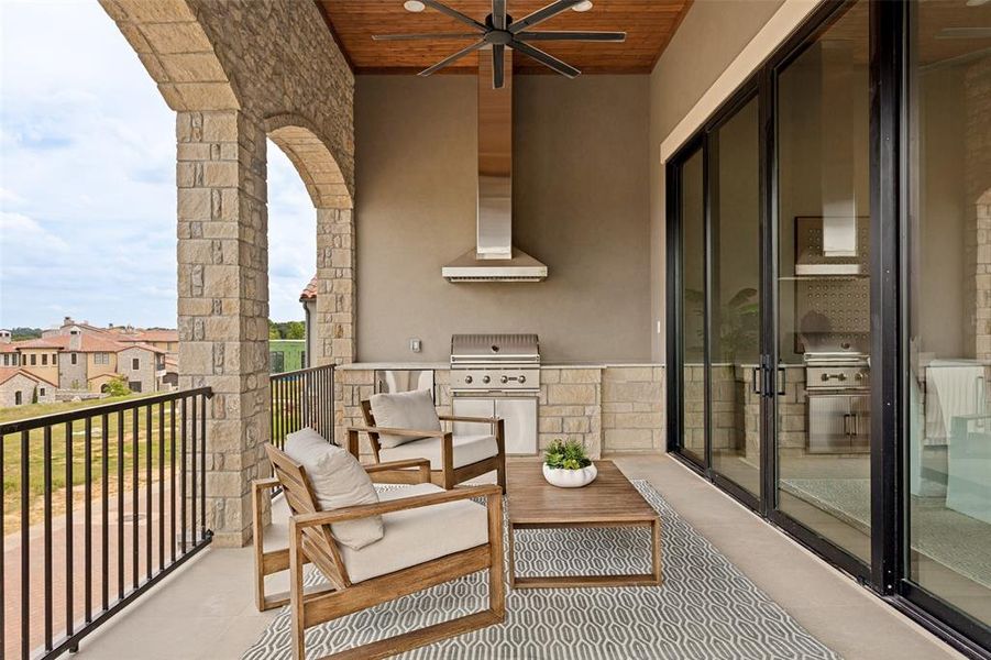 Balcony offers an abundance of seating and a grilling station with vent hood.