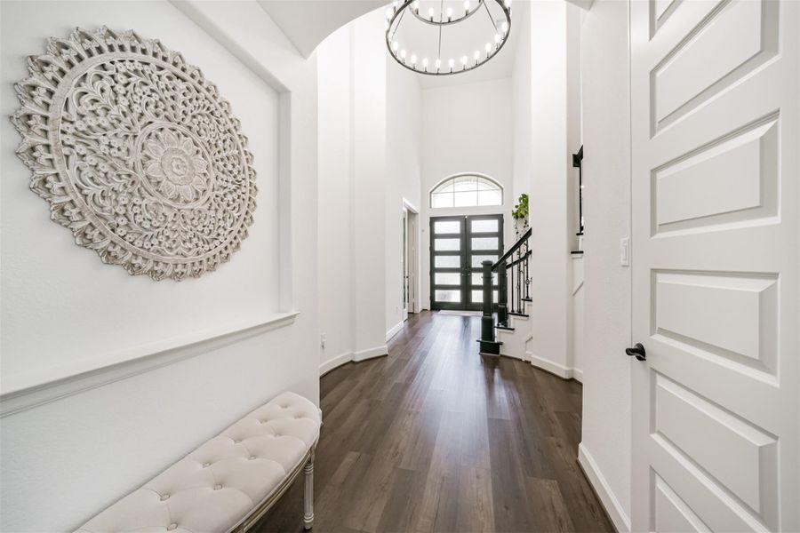 A stunning view of the foyer, highlighted by a bespoke chandelier. A stunning view of the foyer, highlighted by a bespoke chandelier.