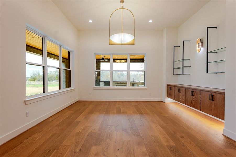 Unfurnished dining area featuring light wood-style flooring and recessed lighting