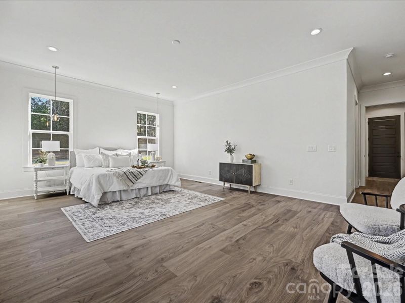 Spacious primary suite filled with natural light, featuring oversized windows, an open layout, and a serene retreat feel.