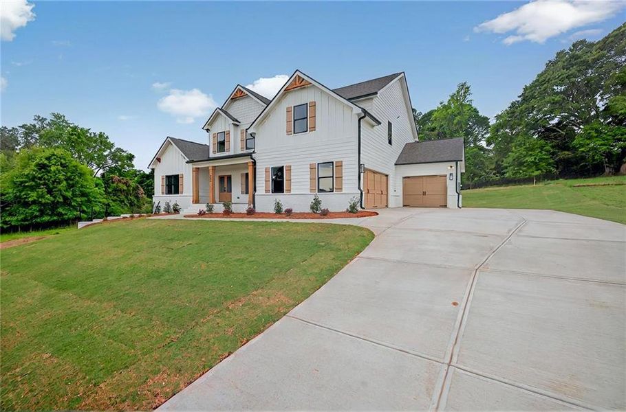 Front exterior of a new home in SteepleChase, Hoschton, GA, highlighting curb appeal (Image 23).