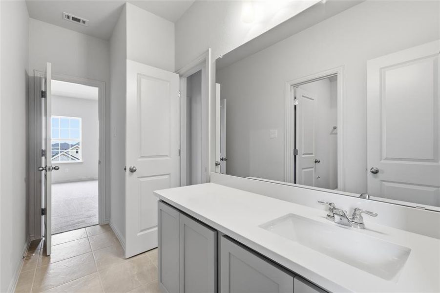 Bathroom featuring vanity and light tile patterned floors