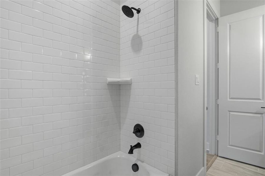 Bathroom with shower / tub combination and baseboards