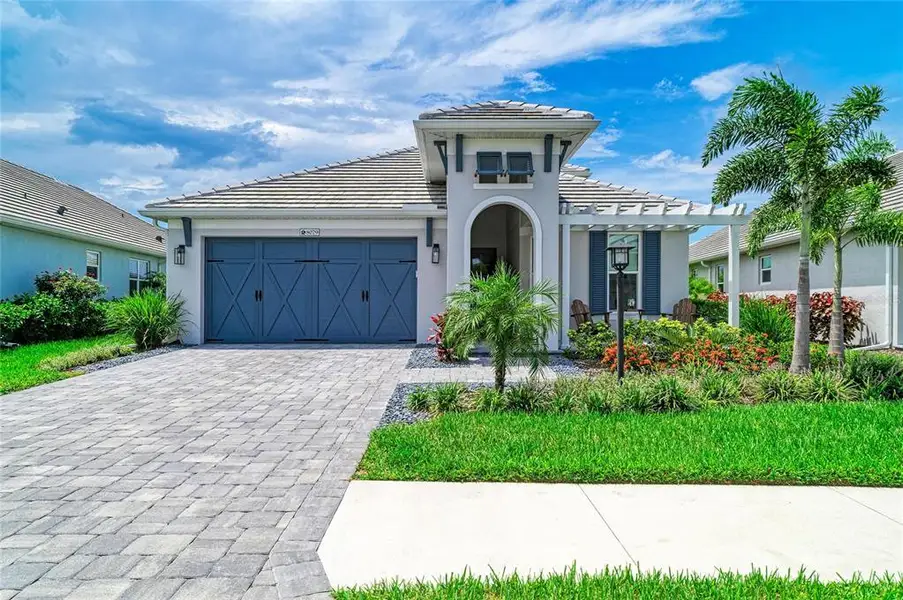 Front exterior of a new home in , Sarasota, FL, highlighting curb appeal (Image 1). Front exterior of a new home in , Sarasota, FL, highlighting curb appeal (Image 1).