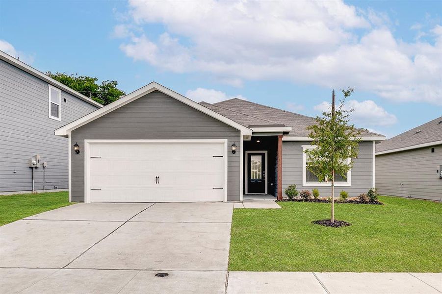 Ranch-style home with concrete driveway, an attached garage, a front yard, and a shingled roof