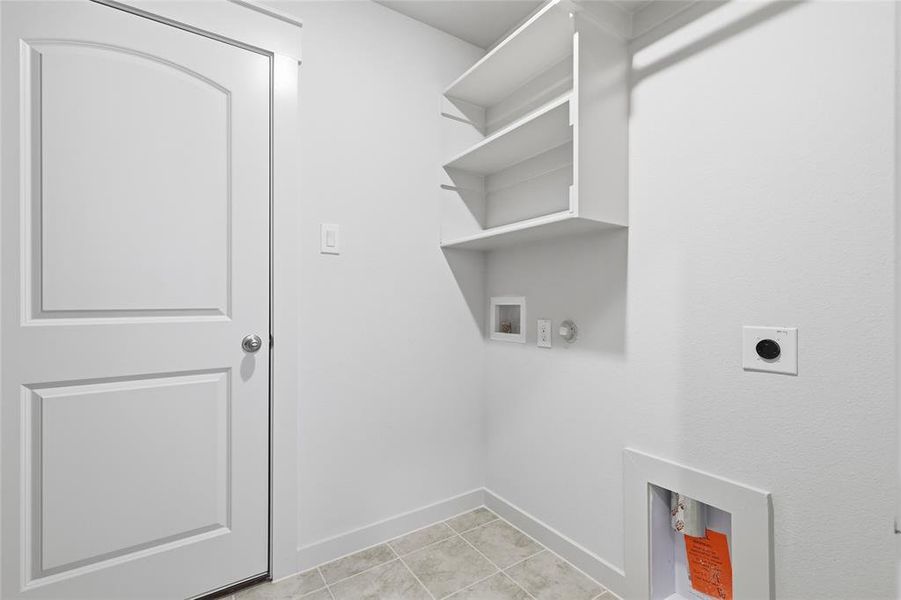 Laundry area with hookup for a washing machine, electric dryer hookup, gas dryer hookup, and light tile patterned floors Laundry area with hookup for a washing machine, electric dryer hookup, gas dryer hookup, and light tile patterned floors