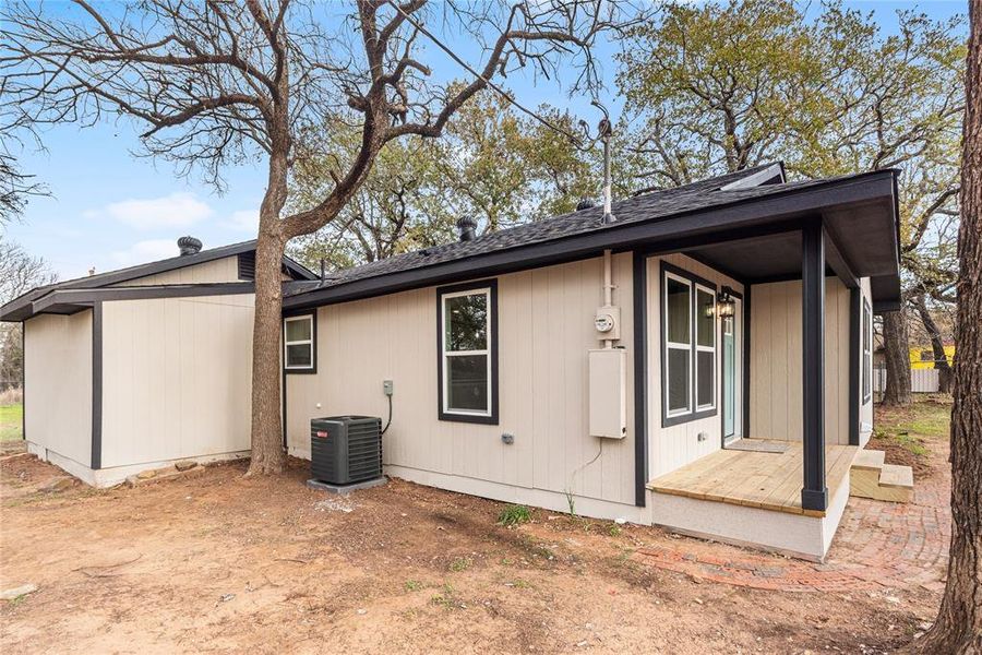 Back of property featuring a shingled roof