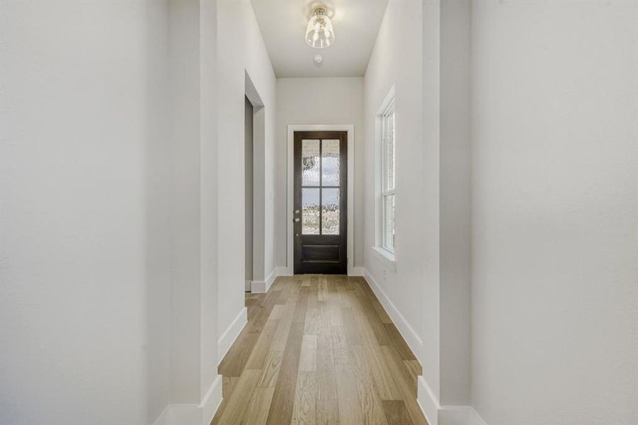 Entryway with wood finished floors and baseboards