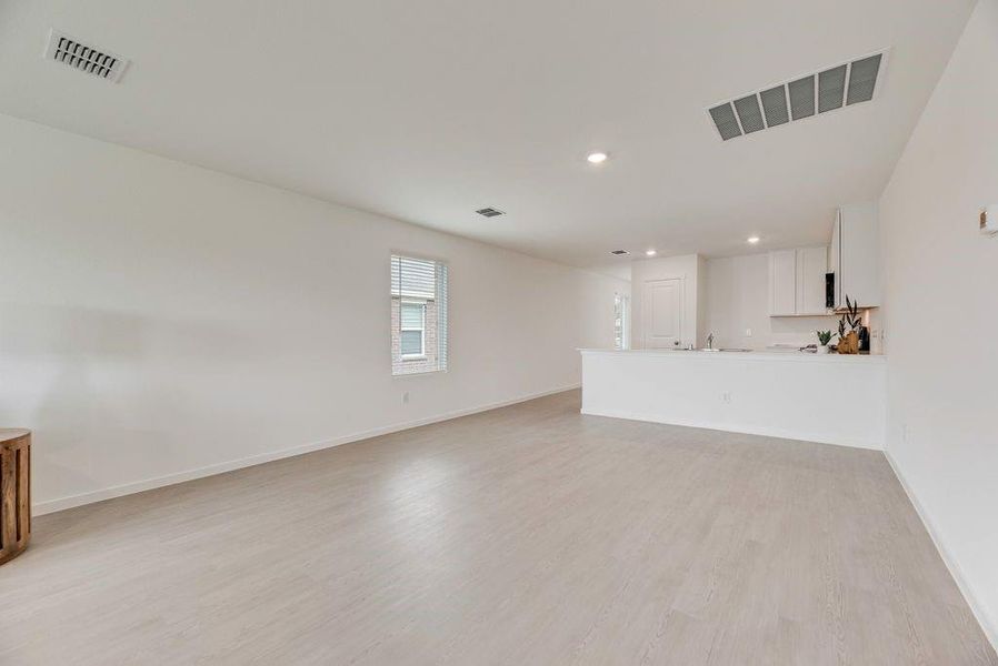 Unfurnished living room featuring light wood-type flooring and recessed lighting