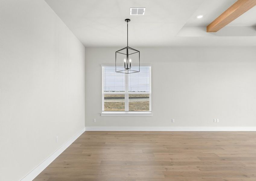 The open dining area has a large window that lets in great, natural light.