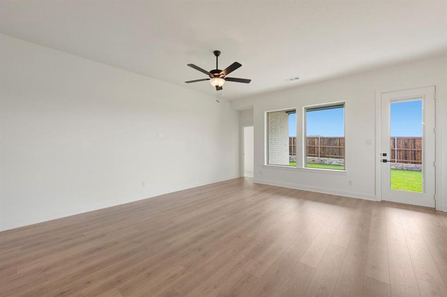 Unfurnished room with ceiling fan and wood finished floors Unfurnished room with ceiling fan and wood finished floors