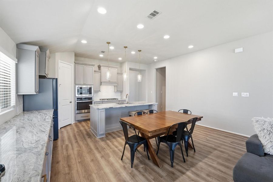 Open plan kitchen with breakfast island, overlooking dining area and family room