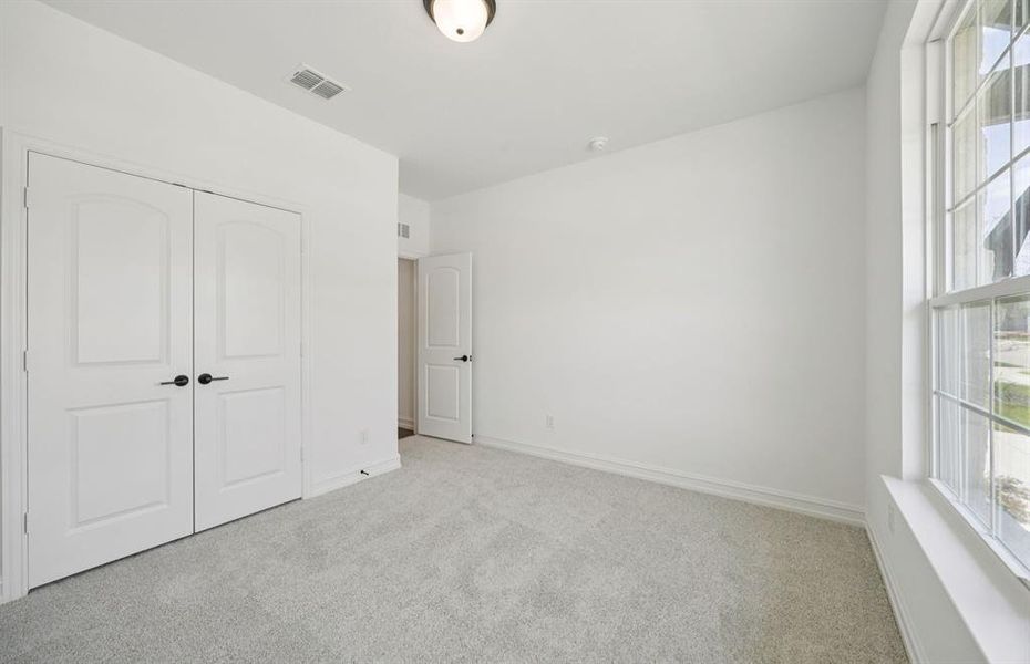 Roomy secondary bedroom with extensive closet storage *Real home pictured Roomy secondary bedroom with extensive closet storage *Real home pictured