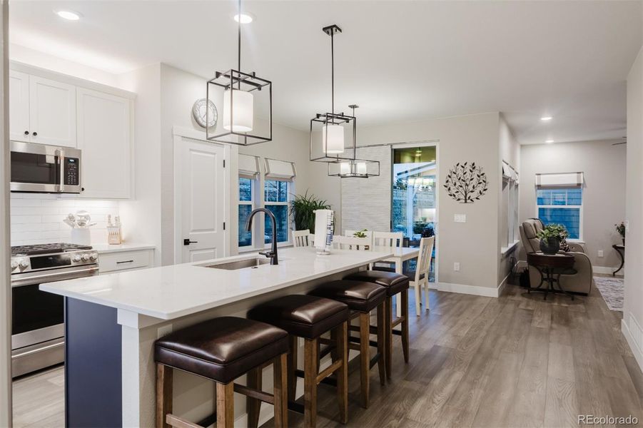 The kitchen has quartz countertops, bar seating and stainless steel appliances. The kitchen has quartz countertops, bar seating and stainless steel appliances.