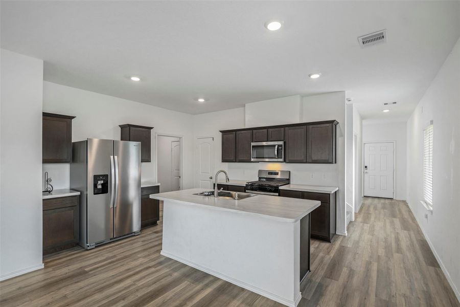 Modern kitchen with oversized island and stainless steel appliances Modern kitchen with oversized island and stainless steel appliances