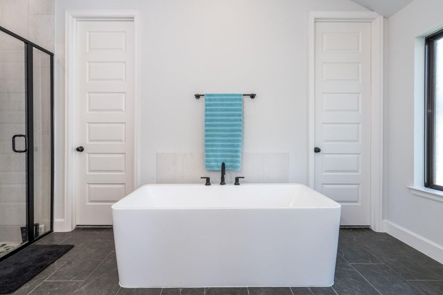 Primary bath has been enhanced with both freestanding tub and a flooring upgrade. Primary bath has been enhanced with both freestanding tub and a flooring upgrade.