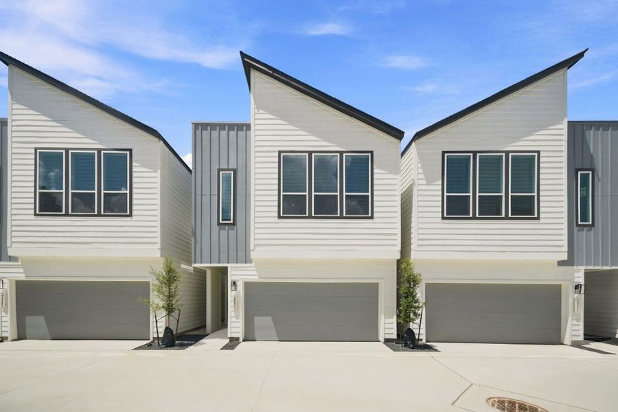 Modern two-story design featuring clean architectural lines, contemporary finishes, and an attached two-car garage. Modern two-story design featuring clean architectural lines, contemporary finishes, and an attached two-car garage.