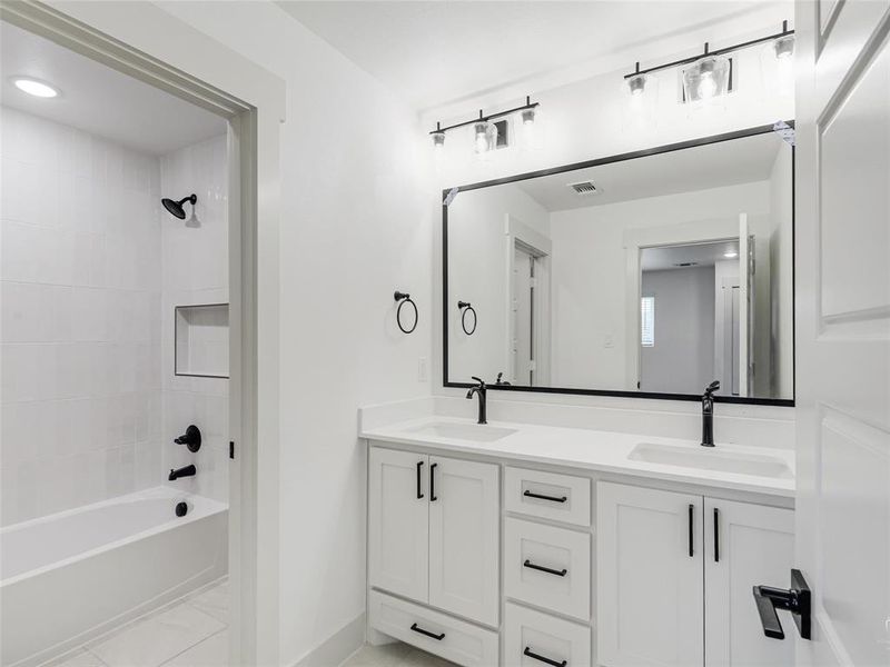 Secondary bathroom with tub/shower combo and dual sink vanity Secondary bathroom with tub/shower combo and dual sink vanity