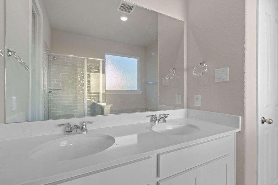 The en-suite bathroom offers a spa-like atmosphere with its elegant design, high end finishes, and tasteful lighting, creating a retreat within your own home. The en-suite bathroom offers a spa-like atmosphere with its elegant design, high end finishes, and tasteful lighting, creating a retreat within your own home.