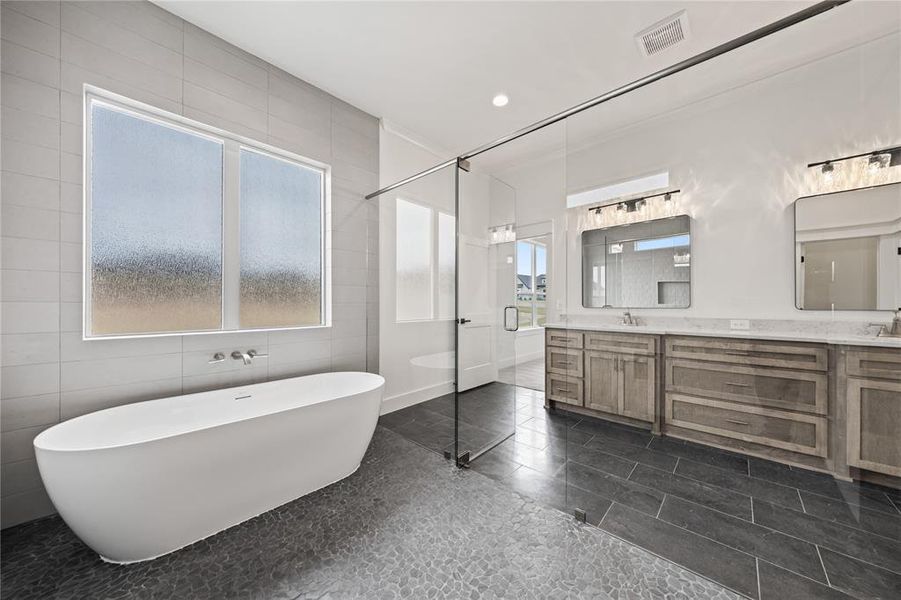 Freestanding soaking tub with wall-mounted fixtures