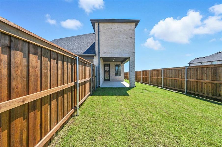 Back of house featuring a patio area, a fenced backyard, a shingled roof, and brick siding Back of house featuring a patio area, a fenced backyard, a shingled roof, and brick siding