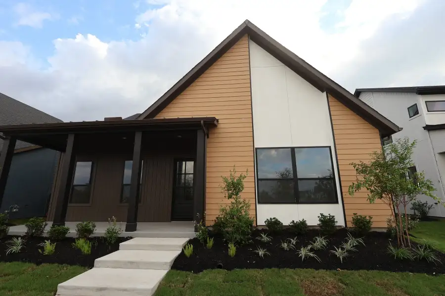 Front exterior of a new home in Bridgeland Central: Emerald Heights - Enclave Row Collection, Cypress, TX, highlighting curb appeal (Image 2). Front exterior of a new home in Bridgeland Central: Emerald Heights - Enclave Row Collection, Cypress, TX, highlighting curb appeal (Image 2).